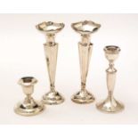 Silver spill vases and candlesticks.