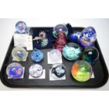 Fourteen glass paperweights by Caithness; and three Swarovski flowers.
