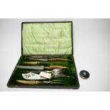 Horn-handled silver collared carving set; and a powder compact.