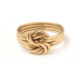 A yellow-metal knot ring.