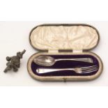 A Victorian child's cased silver fork and spoon set, and a rattle.