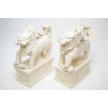 A pair of Chinese Blanc de Chine figures of Fu dogs