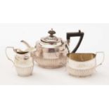 A silver bachelor's three piece tea service.