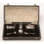 An Elizabeth II cased silver condiment set.