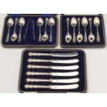 Two cased silver teaspoon sets and a cased set of tea knives.