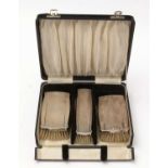 A cased silver brush set.