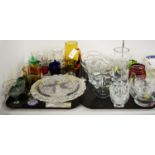 A collection of etched, clear, and coloured glassware.