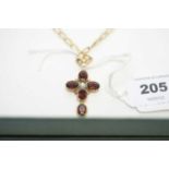 A 9ct gold garnet and pearl cruciform pendant and earrings