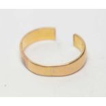 A yellow-metal wedding band