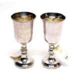A pair of white metal chalices