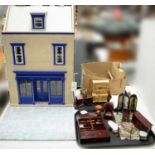 A child's three storey dolls house and a selection of furniture