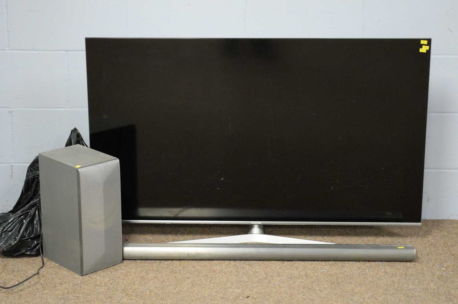 Hisense LED TV, with soundbar and speaker.