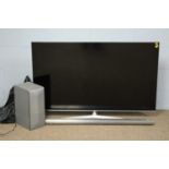 Hisense LED TV, with soundbar and speaker.