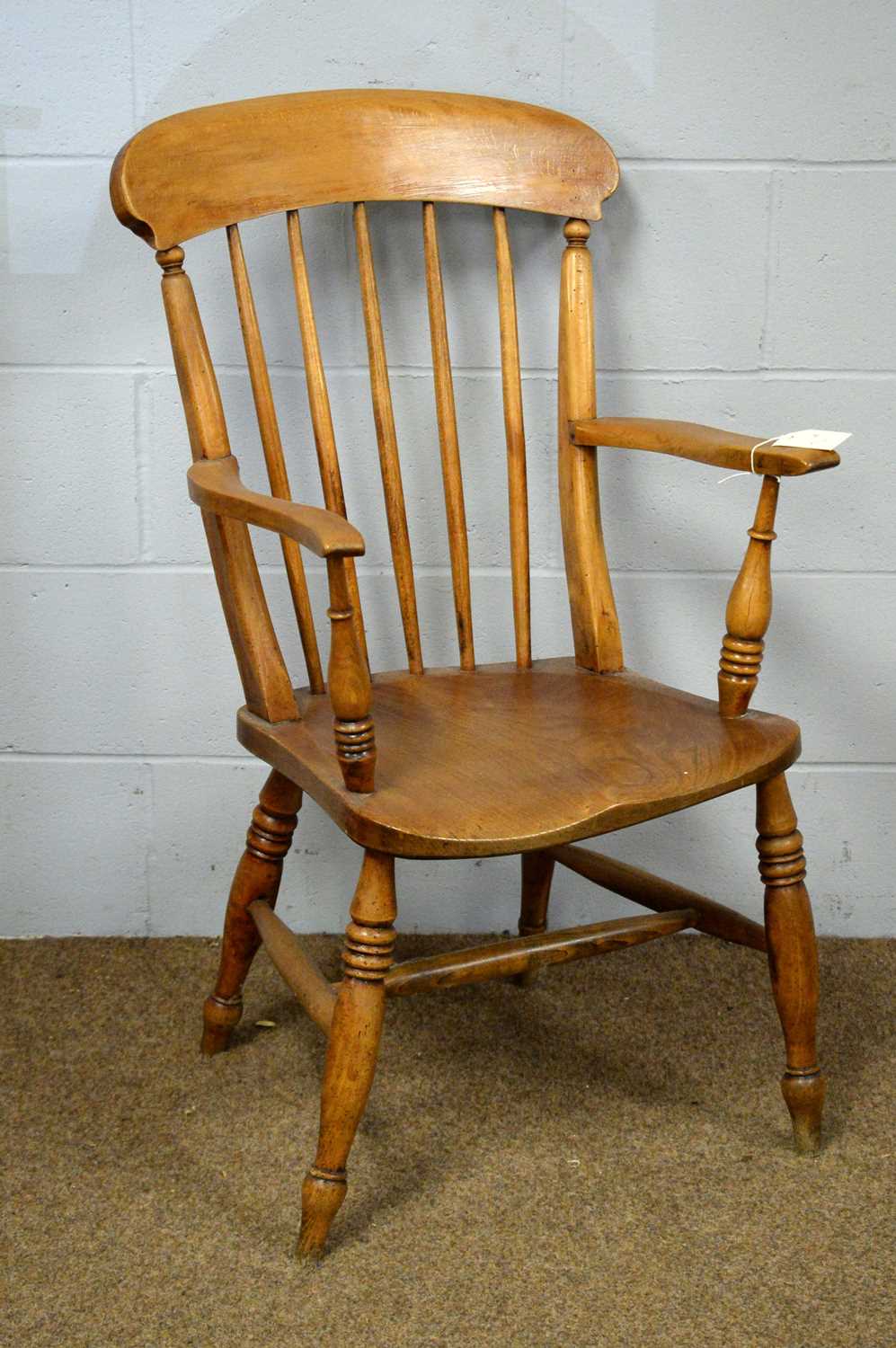 A 19th C Windsor style beech and elm armchair.