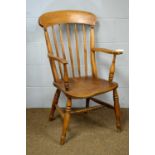 A 19th C Windsor style beech and elm armchair.