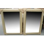 A pair of bevelled wall mirrors