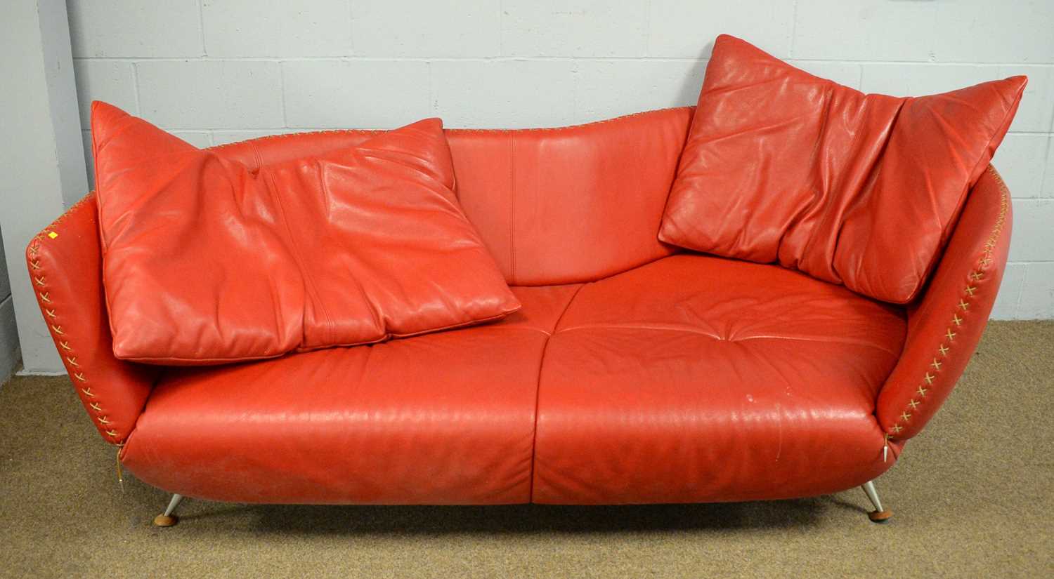 De Sede: a red leather settee.