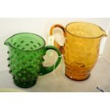 Two coloured glass lemonade jugs.