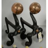 A 19th C pair of cast metal and copper fire andirons.