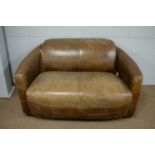 A modern brown two-seater love seat.