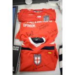 Two England replica football shirts; and an England football T-shirt.