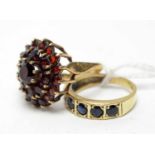 A 9ct gold and sapphire eternity ring and a 9ct gold garnet dress ring