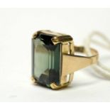 A modern baguette-cut green tourmaline dress ring