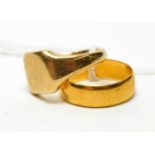 A gold wedding band and signet ring