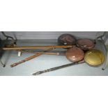 A collection of Victorian bed warming pans.