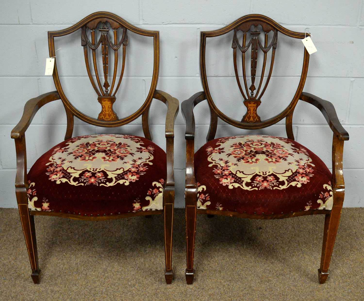 A pair of Edwardian elbow chairs.