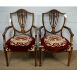 A pair of Edwardian elbow chairs.