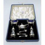 A George VI silver cased cruet set and coffee spoons