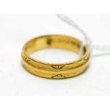 An 18ct gold wedding band