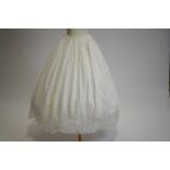 An 1850s white cotton petticoat with crown motif