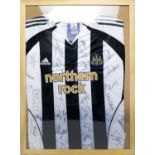 A Newcastle United home shirt signed by the team.