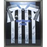 A Newcastle United signed football shirt.