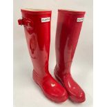 A pair of red Hunter wellington boots.