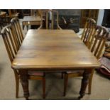 An early 20th C extending dining table and five chairs (4+1).