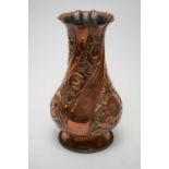 An early 20th Century hammered copper vase