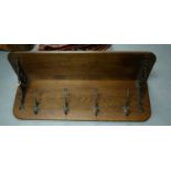 A late19th/early 20th Century oak wall-mounted coat rack