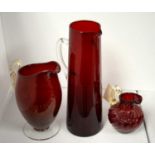 Three pieces of cranberry glassware