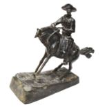 After Frederic Remington: a bronze cowboy on horseback,