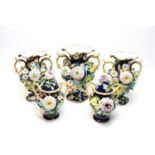 Staffordshire three piece encrusted garniture and pair of covered vases