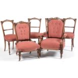 A six piece Victorian carved and pierced walnut salon suite