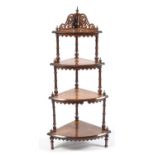 A Victorian burr walnut graduated four tier what-not