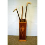 An Edwardian-style inlaid mahogany stick stand and three sticks