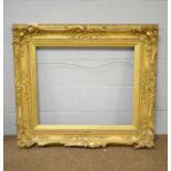 An ornate late-Victorian gold-painted picture frame