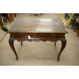 An ornate Georgian-style mahogany side table