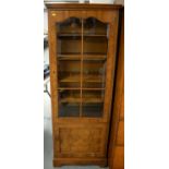 An early 20th Century walnut display cabinet.