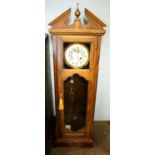 A German walnut-cased wall clock circa 1900